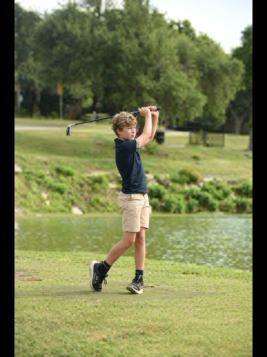Junior golfer's finish on a par-3 over water
