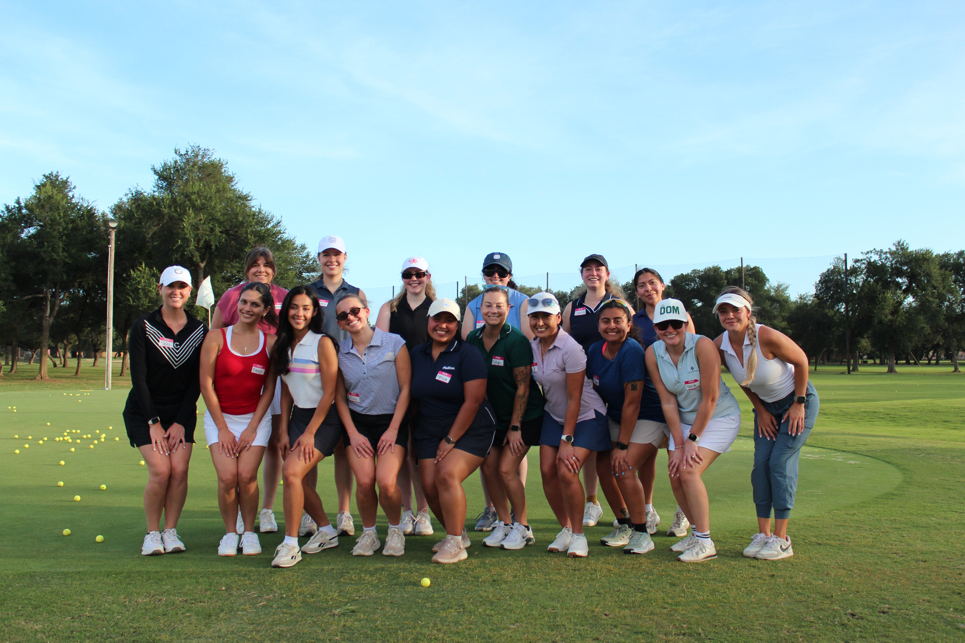 Group of women golfers gathered together on the range at a Beyond Golf Performance clinic